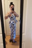 This dress fits pretty well and looks very classy. It was a little looser than expected but not enough to warrant alterations or another size. I know the material says that it doesn't stretch but it actually does have some nice give to it. I am curvy and I was worried the material would be too stiff and tight but it wasn't. Also, no bra needed (unless you have larger breasts maybe). Ignore the shoes in the photos! I was just putting heels on to see for height. I may consider hemming it a little but I think it looks fine if I don't. - Gabriella