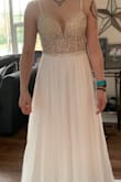 I ordered this as a budget friendly wedding dress but with the Coronavirus chaos happening, I may have to postpone the wedding. The dress was even better quality in person than I expected. It's very fitted and detailed on top, and simple and elegant and flowy on bottom. It is potentially see through so careful of your undie color choice = 
Also, I am 5'4 and got a size 2 dress but I would definitely have to take a few inches off the bottom because it's extremely long in the front - Alyssa L.