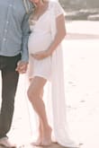 I was crunched on time to be able get a dress for our maternity photos this was PERFECT! Normally, I would be a small, but given the extra little person I'm carrying around (31 weeks) I ordered large. It was actually way too big and I preferred it open with the slip exposed and the drapery part flowy. So thankful this dress pulled through last minute!! - Claire W.