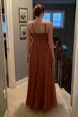 It arrived in 9 business days. Ordered this to wear as a bridesmaid dress. The wedding will be in September. It has a good weight and the adjustable straps are perfect. The dress is the perfect length with heels. - Emily D.