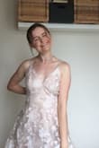 This dress is absolutely stunning and makes me feel like a princess every time I try it on! The fabric is very light and flowy and the floral print with little silver details are gorgeous. However, the top and waist are really big on me so I'll need to get it tailored to fit better and look more flattering. Something the surprised me was that the skirt has a lot of fabric, which is fun for twirling but makes it harder to walk in. It's also a few inches too long for me so, even while wearing 2-inch heels I have to be super careful. The length and super fully and flowy skirt and really pretty but a bit awkward from a functional standpoint. - Shawn K.