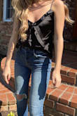 This top is absolutely adorable and SO trendy! The silky fabric is incredible. This tank top can be worn dressed up or dressed down. I opted for some slightly ripped, light wash denim jeans with sandals. It fits true to size and has adjustable straps. It is very flattering and it fits more snug up top with a more loose fit towards the bottom. I would definitely recommend! - Erica M.