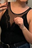 I bought this to wear out for a girls night and paired it with a leather jacket. This definitely fits true to size and I purchased a small and medium. I kept the medium because it wasn't as tight as the small and had a little more coverage in the upper chest area. - Alex R.