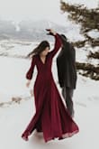 Loved this dress, I got so many compliments! The plum color is great contrast against snow. Had to iron it under low heat to get the wrinkles out, that took about a half hour. The wrist is really tight, you have to undue the little buttons before you put it on. I got an XS because I was worried the v-line would be too low, and I wanted to wrap it as tight as possible. I also used double sided tape against my bra to keep it from opening. I'm very small chested but this dress accented all the right places. It's a bit complicated to get into, and the length is a little long, but I was on snow and it covered my snow boots nicely! After I wore it I threw it in the wash (regular wash, since I only bought it for the engagement photos and didn't intend on wearing it again) and was surprised it came out of the dryer perfect, no wrinkles or anything! - Amy N.