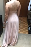 I'm 5 ft 5 inches and 130 pounds. I'm a 32d and the Xs fit perfectly. Because this is a lower cut dress in the back, you almost have to go with the smaller size so it holds the bust in tighter without a real bra. I'm using an adhesive bra which works perfect with the dress. - Shelby M.