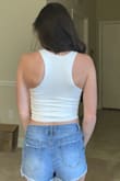 I love how soft the material is and how nice this top fit. It's an adorable crop top and fits true to size. I purchased both this white one and the yellow version. They're perfect summer tops and they'll go well with high waisted shorts! - Gabrielle D.