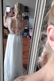 I loved this dress! The top is more beige than white but the beading is beautiful! The dress is long on me but I am 5 foot 2 inches. Could easily be hemmed. I bought this dress twice but ultimately sent back both times because as much as I wanted to love it on me it just didn't feel like the one. Its beautiful though! You must try it for yourself! - Jessica A.