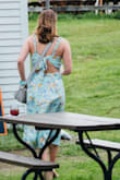 Dress is a great color and print however the tie in the back of the dress offers very little chest support and I found that although I'm usually a true medium I was unable to tie the chest as tight as I would have liked. Wore the dress to a wedding and it was fine. - Chelsea C.