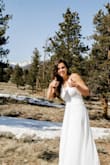 I bought this dress for my mountain elopement after my wedding was cancelled due to COVID, and it was great! I loved the flow-y nature to it and the lace at the top really adds to the beauty of it. The only thing I would say is for us shorter girls- it's really long. I had 3 inch heels on and it was still too long. I couldn't get it hemmed due to COVID closures, which wasn't a huge deal for our situation, but will definitely get it hemmed in the future for my rescheduled wedding time frame! - Ciara B.