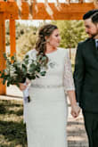 This is a beautiful on a budget wedding dress! I wanted a classic lace dress for my intimate wedding ceremony but almost didn't order this one because it seemed too plain. I'm so glad I did, because it was my favorite of the 3 I tried. The back was my favorite part! I'm 5'6 and very pear shaped. The large was snug but perfect and also the perfect length (had to keep my shoes under 1 inch high). I lucked out, because the top lace overlay was longer than the lining. However, I also ordered this in the XL for fit comparison and that dress the overlay was definitely shorter and would have needed alterations. The only thing I had to adjust myself was where the zipper base was sewn in to the lining. There was way too much fabric at the bottom of the zipper, which made it look like a big round lump on my butt. I carefully (and nervously) used some heavy duty scissors to cut some of the fabric bulk out so it laid flatly. Only thing I added was a sash. All in all it's a beautiful dress & I would absolutely recommend! - Julie W.