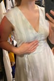 I loved the dress at first - fabric, color, just as expected. Fit perfect. I usually wear a Small in Junior or size 0. The belt is removable which is nice for layering. 
However, the neckline is too low for me, bending over would definitely expose some bra/cleavage, especially for those with smaller chest. Also the closure with the slit gaps in a weird way. These two things make it uncomfortable for me to wear this dress, I'd have to be constantly yanking and pulling. I was hoping the dress would work! - Anna U.