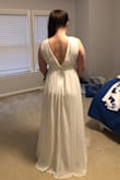 Ordered this dress as one of the three I am going to get married in next month. Very pretty but a little loose in the bust. As you can see in the photos, the fabric is a little loose and billowy by the breast. Thick enough not to need a bra or anything which is great. Great length for us giraffes and I loved the deep V on the back. If this was the winner, I would've hemmed it a little bit and gone to a seamstress to adjust the fit of the bust. Great quality, there are several layers in the skirt. Four stars for the fit, but definitely could've made it work. Such an affordable option! - Shelley C.