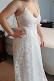 I gave this dress 5 stars even though I decided to return it, because I honestly loved it. The dress is gorgeous, excellent quality, fits true to size chart, and absolutely screams bridal. The reason it didn't work for me is because the crisscross straps are just not enough to hold up a larger bust size without also wearing a bra. I had to pull the straps super tight to even attempt to securely hold me up, which in turn had the straps digging into my shoulders and back. My advice is to consider your bust size and what type of support you realistically need. Otherwise, absolutely buy this dress!! I am so sad I wasn't able to wear it. :( - Cara R.