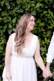 I wore this for my wedding and it was perfect. The dress fit perfectly according to the size chart. I measured myself before I ordered. I had it hemmed on the bottom and the bust nipped in on the sides to make it fit well. I wore a bra with an ivory lace bandeau that I have had for 10 years. I need the support of a bra, and the lace bandeau gave me coverage so that I felt confident and not too flashy. I highly recommend the dress! - Carlene A.
