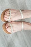 I wear a size 5 with open-backed sandals and I got the size 5.5 and it fit perfectly. There is a small overhang on my heel which I find very sexy. I mean that the sandals are slightly shorter than my foot length.  The straps are very comfortable and snug on my feet. - Rene A.