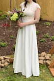 My now-husband and I had to postpone our wedding due to the coronavirus, but we opted to still get married on our original date. My original wedding dress wasn't going to be available for that date (alterations weren't done, and the boutique was closed), so I had to find a new and affordable dress. This was PERFECT for our day, I felt like a beautiful bride, and luckily it only needed minimal alterations (~6-8 inches hemmed off). It's a bit heavier than it looks, but by no means uncomfortable. It was actually very movable and flattering. Not a lot of give in the top half, but that was fine for me and this size. So happy with how the day went, and glad I opted for this gown! - Erin G.