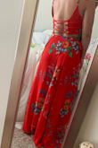 I've never been more in love with a dress. I bought this for a summer wedding that was unfortunately postponed which is why there isn't pics from that. Its very light material and the skirt is "wrap" style which gives you the freedom to adjust the size of the waist if needed. I really like that the slit isn't super apparent while your walking around but you can definitely pop out a knee for a pic and show it off. The length also isn't an issue for me (5'5") as long as I throw some heels on. 10/10 would recommend! - Caitlin M.