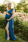 I absolutely adore this dress. I did purchase it in a medium and large, and returned L. pre pregnancy I was a size small weighing 118, now at 34 weeks pregnant weighing 150. With the expanding rib cage I needed a medium because this waistband has absolutely ZERO stretch. I really had to suck in like crazy to get it zipped. The size L on me was way too much material but fit around the waist much better. In a perfect world I may have kept the large and gotten it taken in, but because of covid limitations I squeezed into the medium! Because of the pregnant belly popping out, the top part does kind of overlap into the waistband a bit, but I felt like it added to the sexiness of this dress! The slit it SO FUN. I couldn't have imagined doing photos in a dress without this slit. It was perfect. The royal blue color is beautiful. I also ordered the denim blue and it was much darker than I had imagined, so I returned that color. I would highly recommend ordering this for your maternity shoot!! - Nicole B.