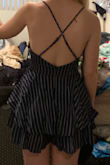 This romper definitely looks as pictured! Very cute, but fits a little loosely and it's pretty short! I probably would've sized down for a tighter fit, but the romper is already very short as is. Like, DO NOT BEND DOWN in this thing or the world will see the entirety of your cheeks. The material also gets a bit wrinkly, but it's less noticeable since the romper is pretty dark. Otherwise, it's super cute and perfect for summer days! - Katie O.