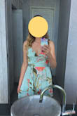 I wore this dress to a destination wedding. I tend wear a medium in most clothes, but based on reviews, I ordered a small and an extra small. The small fit great. I'm small chested, usually a 36A or B, and felt like the top of the dress suited my body type. I think I would have felt overly exposed if I had a larger bust, as any time I tried to add something with padding to the top, it gaped open. I had trouble finding the right undergarments to wear with this, so I did what other reviewers suggested and settled on silicon pasties, and also used fashion tape to secure the edge of the fabric to my chest. When I sat, I still felt worried that the fabric would fall open, but I don't think I had any wardrobe malfunctions. I felt very pretty in this dress. The weight of the fabric made it feel fancy and appropriate for the occasion. I didn't feel too hot despite the tropical weather. I loved the print and felt like it very subtly stood out among a sea of solid color dresses. - Tessa C.
