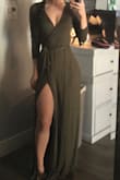 This dress is super cute. It's a wrap dress so the slit is very high but does not open up unless you stick your leg out. It is very low cut but I fixed easily with a little clip. - Laynee A.