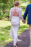 Fits very well. I am short, so a taller woman may not do well with the length if wearing heels. Love the open back. Beautiful, classy, not overdone. Perfect for an elopement ceremony. - Kellie M.
