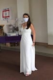 I bought this online in a size small for our small covid nuptial mass wedding ceremony! It runs long (I wore heels and it still dragged), but I didn't have time to get it hemmed. It fit beautifully in the chest and across my stomach. I wore a strapless bra with it. My family gave me tons of compliments! They all loved it and I felt beautiful. It was a perfect dress for our small wedding ceremony. - Lauren D.
