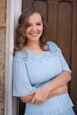 The waist has no give, but this is so, so pretty! I wore it for my senior photos and for an awards ceremony, and I adored it! The color is beautiful and it's very flattering. - Audrey N.