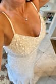 I was so nervous to buy a dress online for my wedding. I was 99% certain it would either not fit or be cheaply made.  BOY WAS I WRONG! This dress is stunning, absolutely flattering and looks like a 1,000.00 dress! It is too long for me, but I am going to have it altered. I did not want it tight so the large was perfect for me but if you want it to be snug, maybe get a size smaller? - Elizabeth F.