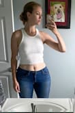 This fits a bit shorter on me than I was expecting, and I'm still unsure how I feel about the fit of the neckline and underarm area, but I talked myself into liking it :) It's thicker material than expected yet still pretty see through; very comfy though! And I love the racerback. - Amanda T.