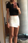 This is hands down the best article of clothing I own. It's stretchy, so it's very comfortable. It feels a little short, but then you look at the back and remember that it's a skort, not a skirt, and you don't feel so exposed. I bought the featured top which goes great with the skort, but the first time I wore the skort, I opted for another Lulu's classic top since it was a little chillier in the evening. Both the tight top and loose-fitting top looked great! I got sooo many compliments on it. My only qualm is that you can see the skort seam in the front under the skirt. It got better as the night went on and the skirt stretched a little, but you can definitely see a line down the front that's a little annoying. 
I love this skort! Definitely buy it if you're on the fence! - Joslyn B.