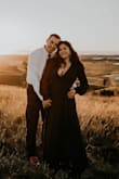 I had been looking at this dress for months in the burgundy color for our engagement photo shoot. By the time I was ready to purchase it, the burgundy was sold out. I was worried that the navy would blend in too much with my dark hair, but our photographer said it would be fine. I'm so glad I decided to get the navy! The quality of this dress is amazing, the lining feels so luxe. The skirt is  very long, and if I was wearing it anywhere but for a photoshoot, I would have had to have it hemmed. But I left it long specifically for pictures, and the slit and length added so much movement and drama to our pictures. I'm very busty, so I had to do some major taping to get the girls to sit right, and I really should have pinned it at the bottom, but it worked out fine. In the future, I'd probably put a small snap in at the bottom of the neckline to help hide the boob tape required. If you're very busty like me you likely wouldn't be able to wear a bra without it showing. - Norlyn F.