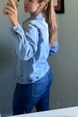 Fits a little oversized which I love. I can wear it over a hoodie or sweatshirt for layering, and the sleeves are a nice length to feel cozy. The light wash is great because I can wear it with my denim jeans without looking too matchy matchy. - Amanda T.