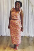 I absolutely loved this outfit! I wore it to a wedding and got SO many compliments! I did order a L when I wear a M, thats mainly because Of my  butt and hip areas, so I did have to bring in the waist and the top a bit. Material is stiff, but I think it works for this look! Absolutely LOVED it! I'm also much shorter than the model, but opted out of hemming the top or skirt! - Samantha B.