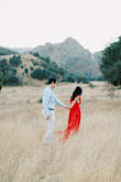 I loved this dress so much!!! It was exactly what I was looking for our engagement session - I wanted it to be flowy and have the perfect shade of red color to contrast with the golden grass in California :). Few issues I ran into - it is long, but I'm also super short. I didn't tailor it prior to the engagement session since I wouldn't really need to walk that much with it (and could just carry it), but if you plan to use it for an event you may need to tailor it on the bottom - which I plan to do now for whenever I use it in the future. The XS was a bit tight around my waist, but I was able to close it and still be comfortable! I think I didn't want to size up in case it would be too big at the shoulder areas and fall off. It is a deep low cut V-neck, so you could stitch it or use a pin to at the V-neck area if you want to. Overall I HIGHLY recommend it - the shade of red is vibrant but not too much, super flowy for pictures, and the material is truly of high quality. - Cindy C.