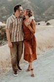 bought this dress for my engagement photos because I loved how casually elegant it was! As is shown in the photo, if you tie the dress off to the side and keep it loose, it creates a clean line across the front with a loose fit. If you want a little more of a fitted look, you can tie the side a bit tighter, but it will pull that "line" up at an angle a bit-still really cute! The only thing I would strongly suggest is to wear skin colored garments underneath, maybe even a slip, because from the back you can and will see darker under garments. It is slightly sheer! From the front you wouldn't know the difference, but the back WILL show darker underwear and lines!! Other than that, so cute!! Perfect for Fall. - Casey S.