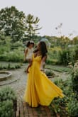 Perfect. In every way. Flattering. Well made. High quality. Flowy. Drapey. Perfect floor length (with the right heel height) that gives that floaty vision! Lots of layers. Just - BEAUTIFUL! I chose this for a 40th birthday photo shoot, did not wear a bra or tape bc of fast wardrobe change, but could have definitely used some double sided tape for added security. Nicely defined waist too, not just straight up and down and not too padded/fluffy in that area. I cannot say enough good things about this dress. And the color - VIBRANT! Like sunshine. - Tia C.