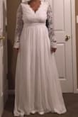 I normally don't wear a medium. But looking at the size chart that's what would fit me best, and it did! The sleeves are slightly long but not too bad. I'm short and needed A LOT of length off. I do wish it had a little more cleavage, but it's mostly perfect and the back is beautiful. The price is a bonus, can't wait to wear it on my big day! - Rachel T.