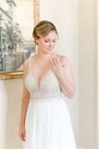 Purchased this dress for my "minimony" wedding and it was absolutely perfect! The only alteration I needed was to shorten the front hem 0.5" but I wore flat sandals. I loved it and felt so comfortable in it. I have received tons of compliments and it was a lot more affordable at different dresses I was looking at when I initially was planning a larger wedding for December 2020. I do think the top stretched out a bit as the day went on but I think that was because the beading is so heavy. And the beading is GORGEOUS. Can't say enough great things! - Adrienne B.