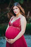 I was having such a hard time finding a dress with beautiful detail for maternity pics. This dress turned out to be so perfect! The color and details photographed beautifully and it showed off my boobs and bump just how I wanted. I am normally a size 4, 125-ish lbs and 5'5". I was 33 weeks and ~155 lbs at the time these pics were taken and the size L was perfect. I am normally a 34B and was wearing a 34D bra at the time. I don't think a bigger bust could fit the top part comfortably or without stretching it too much. So many pros about this dress from the adjustable straps to the ruffle detail on the bottom and waist/bust lace detail. It's worth the money for sure. - Sarah L.