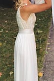I bought this dress for a small intimate family wedding before being able to (hopefully) have a bigger celebration in 2021. I was pleasantly surprised by the quality of the dress. The bottom half has multiple layers so it's not see-through. I had to get it hemmed a bit (which I expected). I did have to get the top taken in (you can see I kind of lost the sheer sides of the dress on the top half). The seamstress I brought it to did a great job and after that it fit like a glove! I definitely don't think I would have sized down, so if you have a small chest like me I suggest being prepared to take in the top. Overall it was an awesome dress and super comfortable. I plan to use it for my bridal shower, and rehearsal dinner for the bigger party/wedding next year! Thanks Lulus! - Caitlin S.