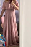 The dress is beautiful! I was worried with it being off the shoulder that it would slip down but no, it feels very secure! It's very long though. If I was a little taller it would be perfect. I'm planning on getting it hemmed. - Danielle L.
