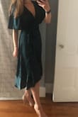 Don't think, just buy! This dress is SO flattering, even if you have a larger chest. It's not too busty, but shows the appropriate amount of cleavage. Wrap dress detailing is super flattering, and the barely there satin is super elegant. Don't wait to buy it, it goes so fast (was on TWO waiting lists for it). I usually wear a M, but saw reviews were that it runs a little large, so the S works perfect. - Madeline R.