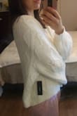 I love the look and feel of the sweater but I wish I got XS, if you are my height and anything close to my weight get the XS. It is baggy around the wrists and it covers way past my hand. it's soft and heavy perfect for cold days. I'm hoping it will shrink but its still cute! - Crisy O.