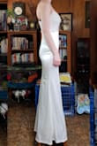 I was pleasantly surprised at how pretty this dress was! It's so much cuter in person. The dress ended up fitting like a glove. The only downside is that it's extremely long. In the photo, I'm standing on a stool so the dress wouldn't drag on the floor. I'm 5'1" and I'd say the dress is about 8 or so inches too long. I do plan on getting it hemmed though. I definitely recommend this dress!

*The side view photo is the dress when I first received it. The front view photo is after the dress was hemmed for my height. - Brittany G.