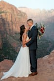This is the most beautiful dress and was perfect for our elopement in Zion National Park. I loved it immediately online, and was just as impressed when it arrived in person. The detail is gorgeous and I received compliments from everyone, all surprised that I spent $200 on it!
The dress is long, but I had it hemmed to make a small train on the back. The chest cups were slightly big for me, I tried various adhesive bras, but none of them worked well/you could see them as the top of the dress is see-through. In the end I decided not to use any additional chest support and was still happy! The dress does tend to pucker the skin at your armpits, so either be hyper aware and continually readjust it, or just embrace it! Overall, I could not be happier with this. I tried quite a few bridal dresses from lulus (and generally really liked all of them!), but this was perfect, my husband loved it too. Congrats to all brides out there reading this! - Bella B.