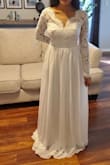 I ordered this for an all white wedding in December. The dress is really pretty in person and appears as a brighter white color than pictured. The material was slightly heavy on the bottom and very flowy. The main issue for me was the bust area appears pointy due to the way it was sewn. The XS size also runs a bit big, as I had at least 2 inches on each side that could be taken in. - Melissa R.