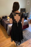 This dress really is beautiful. The lace is substantial and it feels great on. The waist has a small amount of give - fit perfectly on me. At a 34A, I figured this dress would be a bit big on top and I was right. The shoulders felt a bit saggy as a result. The sleeves also have a poofy structure that I didn't expect. I could probably make this work with the right adhesive bra, but I already have a few black lace dresses. Great dress otherwise, just couldn't justify the price with the fit on top! - Ava V.