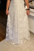 Absolutely love this dress! I knew it was the one as soon as I put it on. It's even prettier in person! I'm tallish, and the length is perfect for a barefoot beach wedding, but may be a little short if you're tall and plan to wear heels. It's a little snug in the waist, but I sized down and it should be perfect once I shed the quarantine 15. I'm smaller in the bust, so the adjustable top works great for me, but may not provide enough support if you're big on top. Can't wait to wear this at my beach elopement! - Samantha C.
