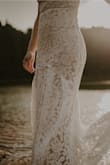 The dress was form-fitting, but still easy to move in for an outdoor elopement shoot.  It was much too long for me so I had it hemmed and also had thin straps swapped in for the adjustable one's.  It's fully lined and the lace looks great up close.  You do have to be careful not to snag the lace, but it held up really well and actually held up to washing.  This dress was a great value and I didn't have to feel guilty about getting it a little dirty. - Lindsay L.